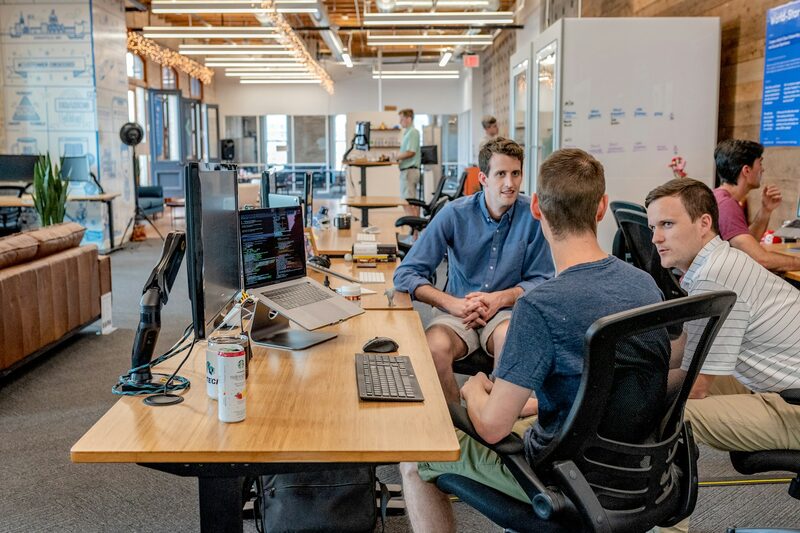 Marketing team discussing campaign plans together in an open office