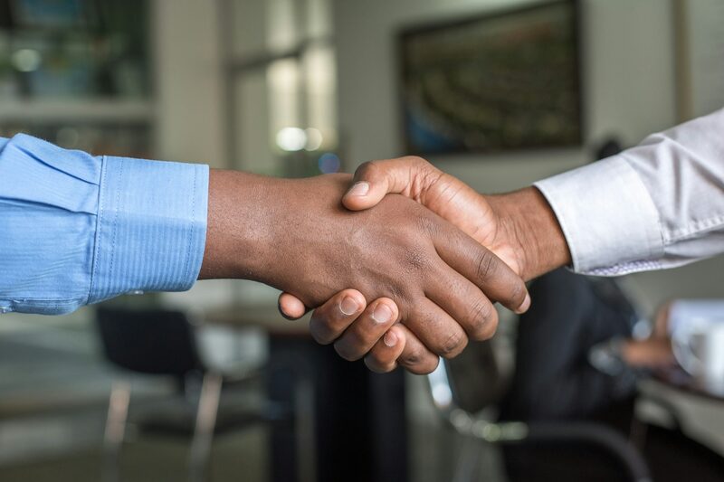 Close-up of two people shaking hands after agreeing to work together
