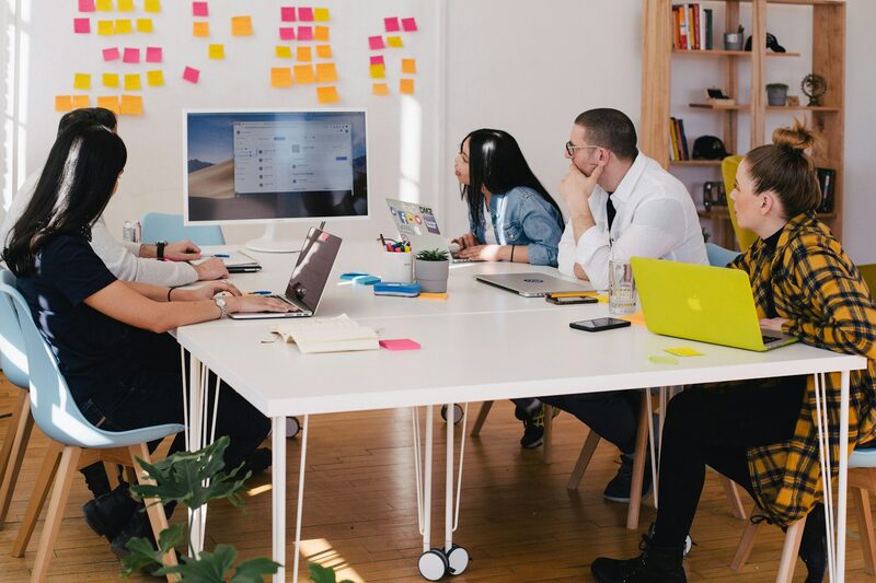 Two professionals in a one-on-one conversation across a meeting table