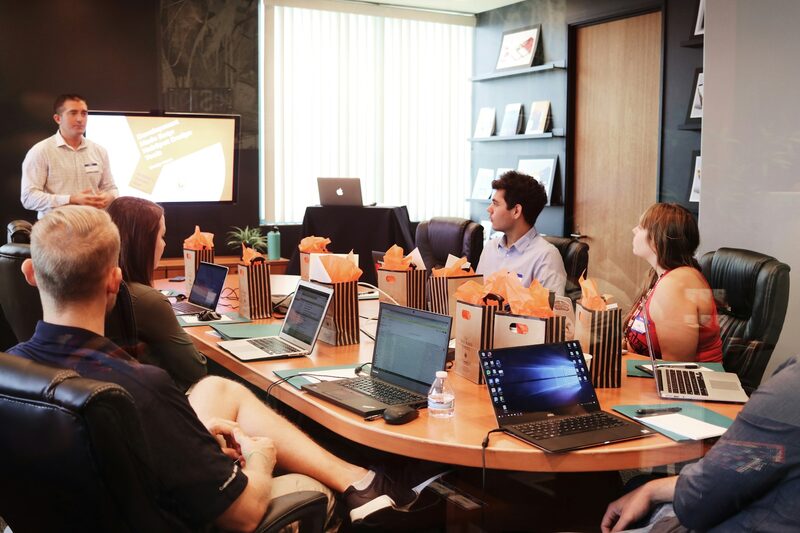 Trainer leading a sales development session for a team in a conference room